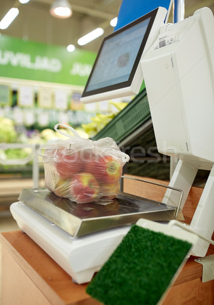 apples in plastic bag on scale at grocery store Stock photo © dolgachov