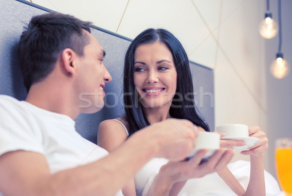 smiling couple having breakfast in bed in hotel Stock photo © dolgachov