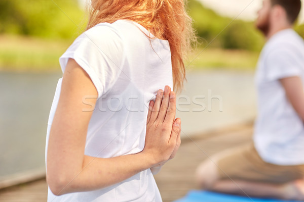 group of people making yoga exercises outdoors Stock photo © dolgachov