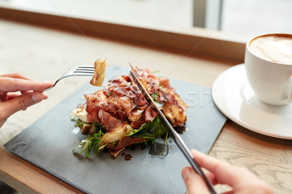 Stock photo: woman eating prosciutto ham salad at restaurant