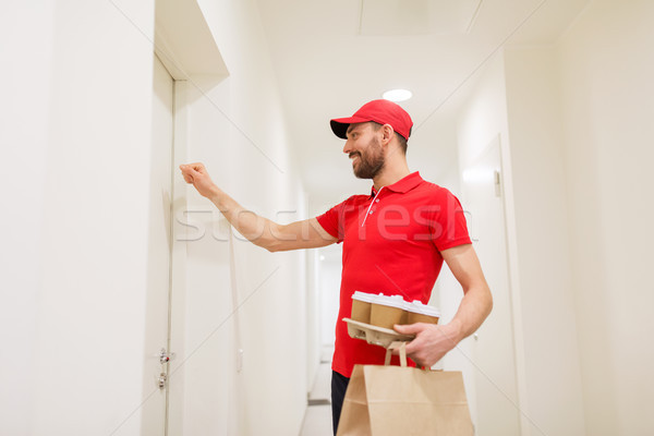delivery man with coffee and food knocking on door Stock photo © dolgachov