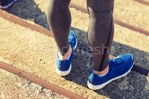 close up of sporty man legs in shoes on stairs Stock photo © dolgachov
