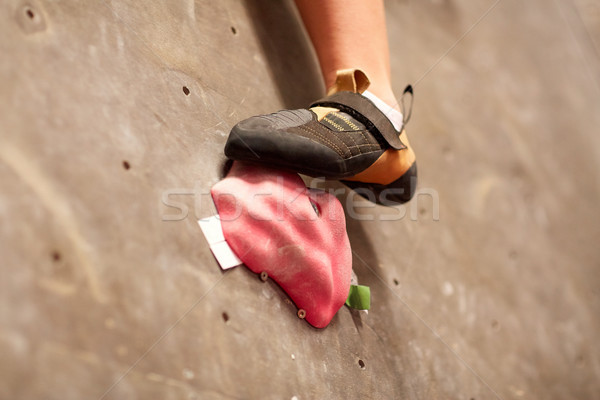 foot of woman on indoor climbing gym wall hold Stock photo © dolgachov