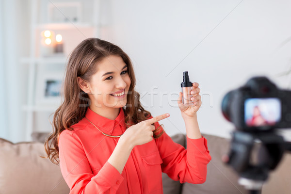 woman with foundation and camera recording video Stock photo © dolgachov