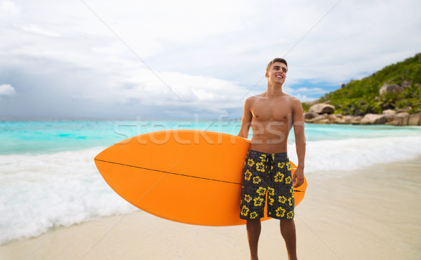 smiling young man with surfboard on summer beach Stock photo © dolgachov