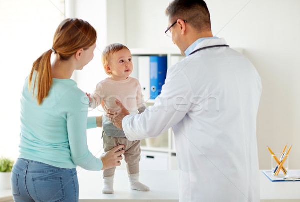 happy woman with baby and doctor at clinic Stock photo © dolgachov