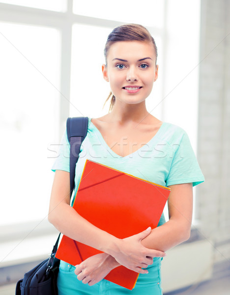 student girl with school bag and color folders Stock photo © dolgachov