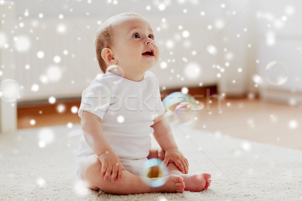 happy baby with soap bubbles at home Stock photo © dolgachov
