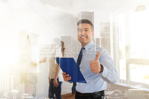 realtor with clipboard showing thumbs up Stock photo © dolgachov