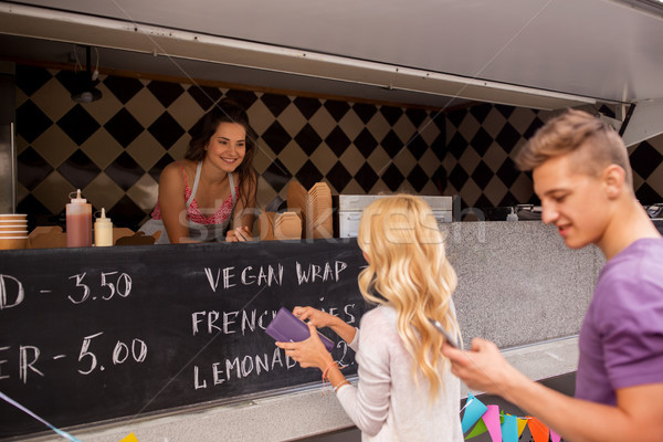 happy customers queue at food truck Stock photo © dolgachov