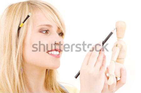 happy teenage girl with wooden model dummy Stock photo © dolgachov