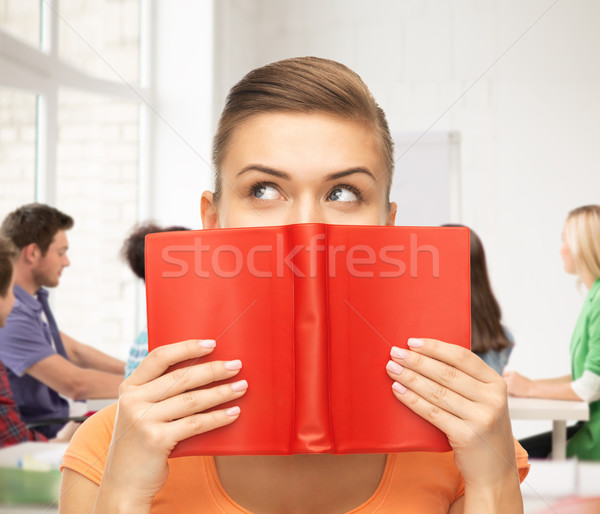 woman eyes and hands holding red book Stock photo © dolgachov