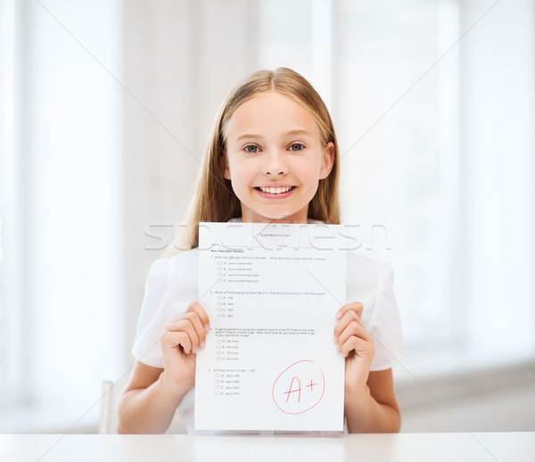 Stock photo: girl with test and grade at school