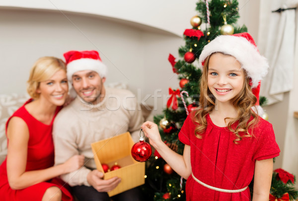 smiling family decorating christmas tree Stock photo © dolgachov