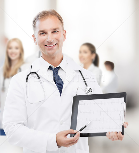male doctor with stethoscope showing cardiogram Stock photo © dolgachov