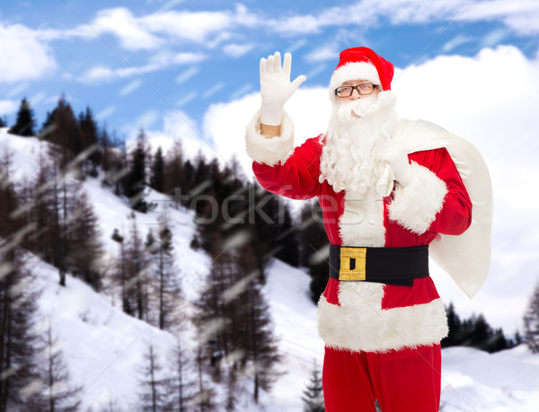 man in costume of santa claus with bag Stock photo © dolgachov