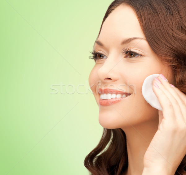 smiling woman cleaning face skin with cotton pad Stock photo © dolgachov