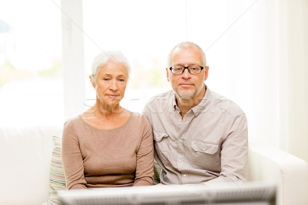senior couple watching tv at home Stock photo © dolgachov