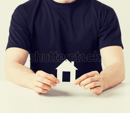 man hands holding paper house Stock photo © dolgachov