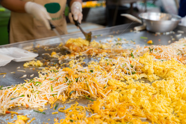 Stock photo: close up of cook frying wok at street market