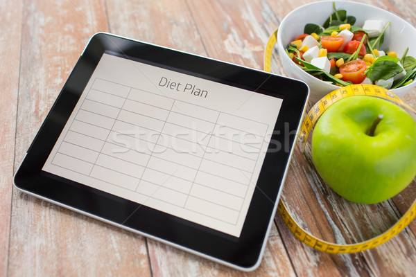 close up of diet plan on tablet pc and food Stock photo © dolgachov