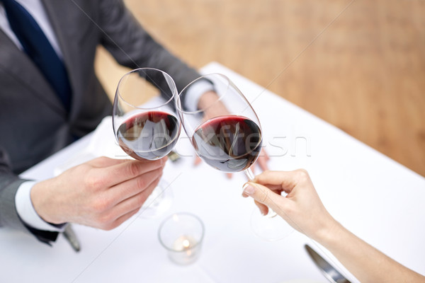 young couple with glasses of wine at restaurant Stock photo © dolgachov