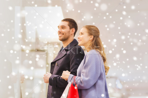 happy young couple with shopping bags in mall Stock photo © dolgachov