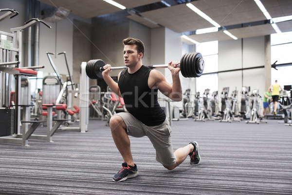молодым человеком мышцы штанга спортзал спорт Сток-фото © dolgachov