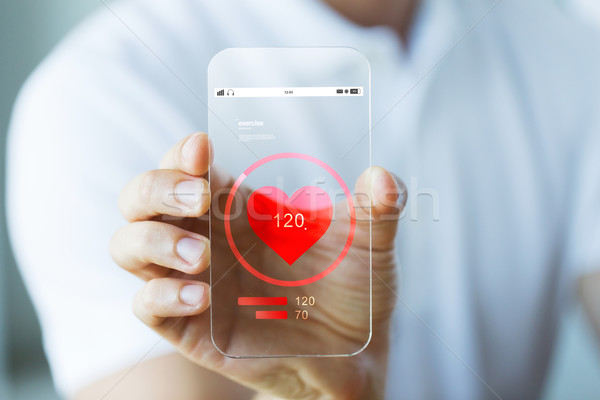 close up of hand with heart rate on smartphone Stock photo © dolgachov