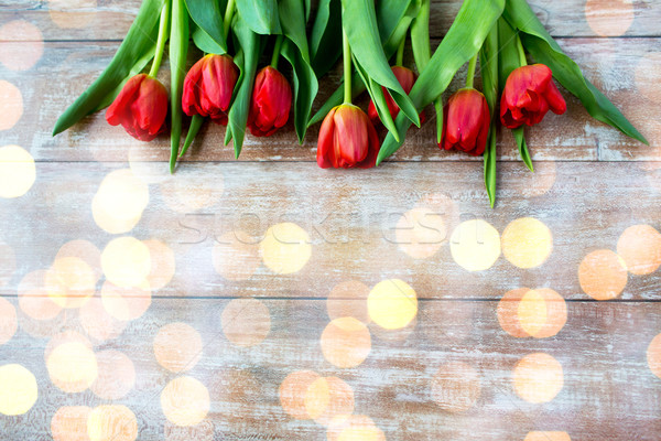 close up of red tulips on wooden background Stock photo © dolgachov