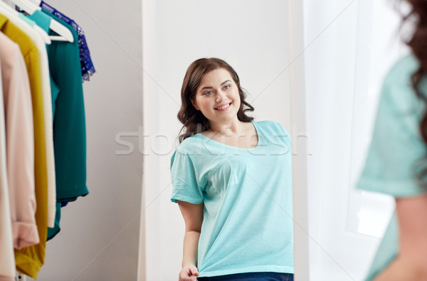 happy plus size woman posing at home mirror Stock photo © dolgachov