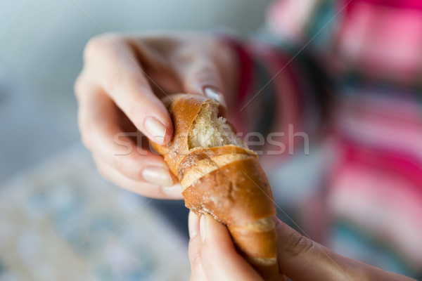 close up of woman hands with bun or wheat bread Stock photo © dolgachov