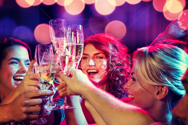 Souriant amis verres champagne club fête [[stock_photo]] © dolgachov