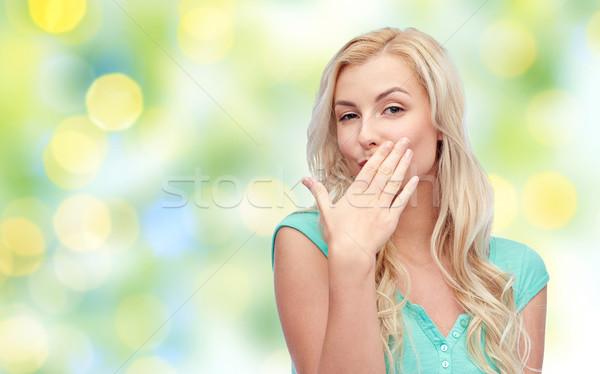 smiling young woman or teen girl covering mouth Stock photo © dolgachov