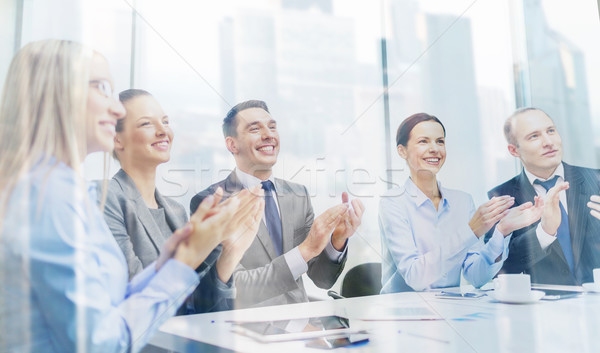business team with laptop clapping hands Stock photo © dolgachov