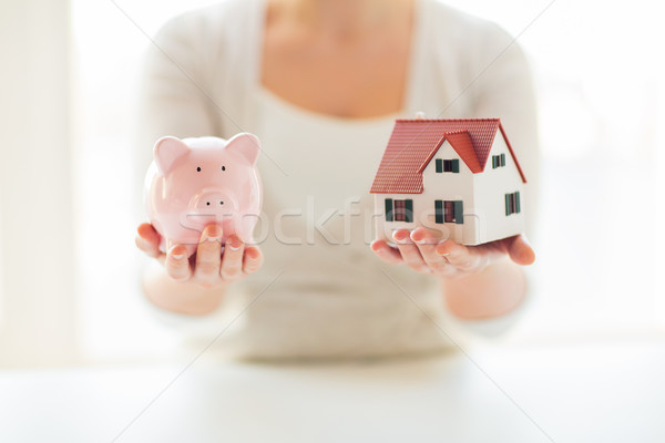 close up of woman with house model and piggy bank Stock photo © dolgachov