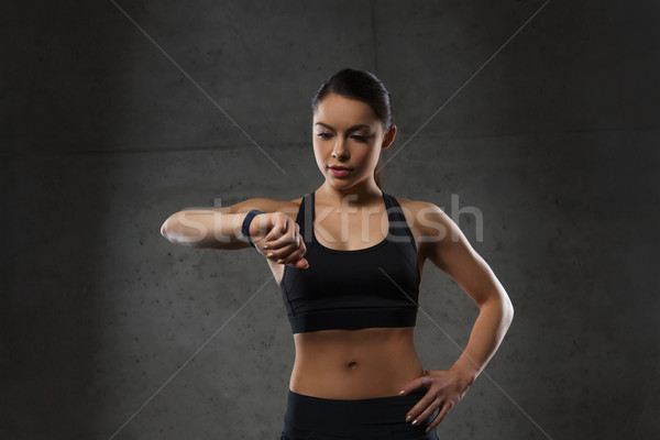 young woman with heart-rate watch in gym Stock photo © dolgachov