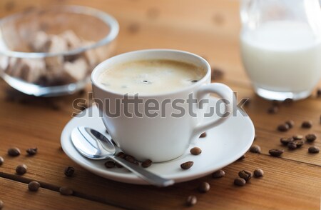 close up coffee cup and grains on wooden table Stock photo © dolgachov