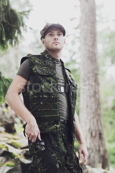 young soldier or hunter with knife in forest Stock photo © dolgachov
