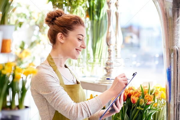 Stock photo: florist woman with clipboard at flower shop