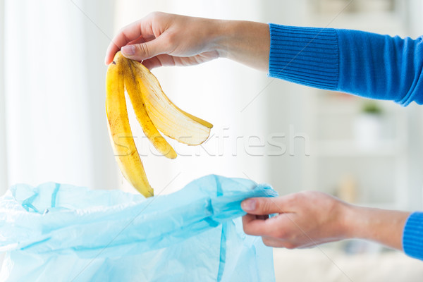 close up of hand putting food waste to rubbish bag Stock photo © dolgachov