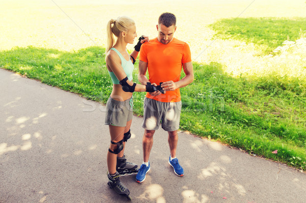 happy couple with roller skates riding outdoors Stock photo © dolgachov