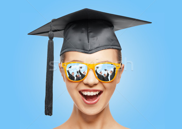 happy teenage girl in shades and mortarboard hat Stock photo © dolgachov