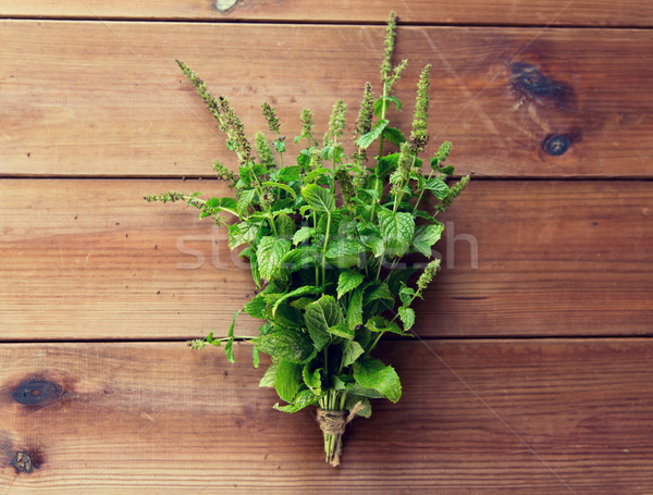 close up of fresh melissa bunch on wooden table Stock photo © dolgachov