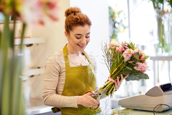 smiling florist woman making bunch at flower shop Stock photo © dolgachov