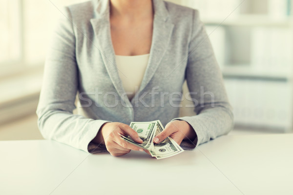 close up of woman hands counting us dollar money Stock photo © dolgachov