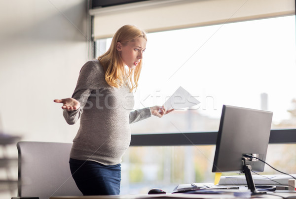 pregnant businesswoman stressing at office work Stock photo © dolgachov