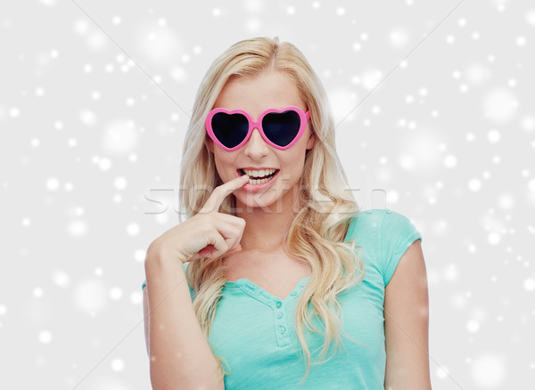 happy woman or teenager in heart shaped sunglasses Stock photo © dolgachov