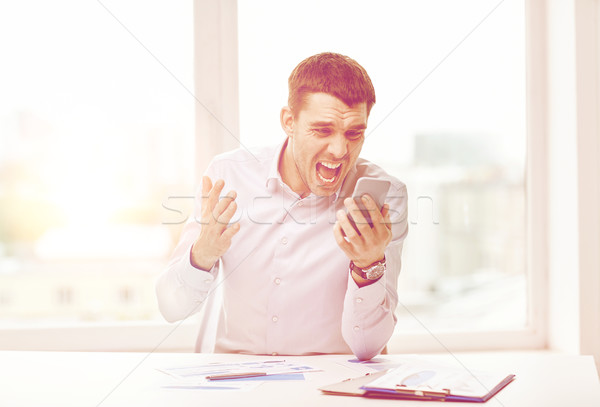 Stock photo: close up of businessman with smartphone