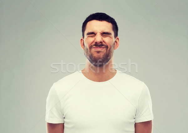 man wrying over gray background Stock photo © dolgachov
